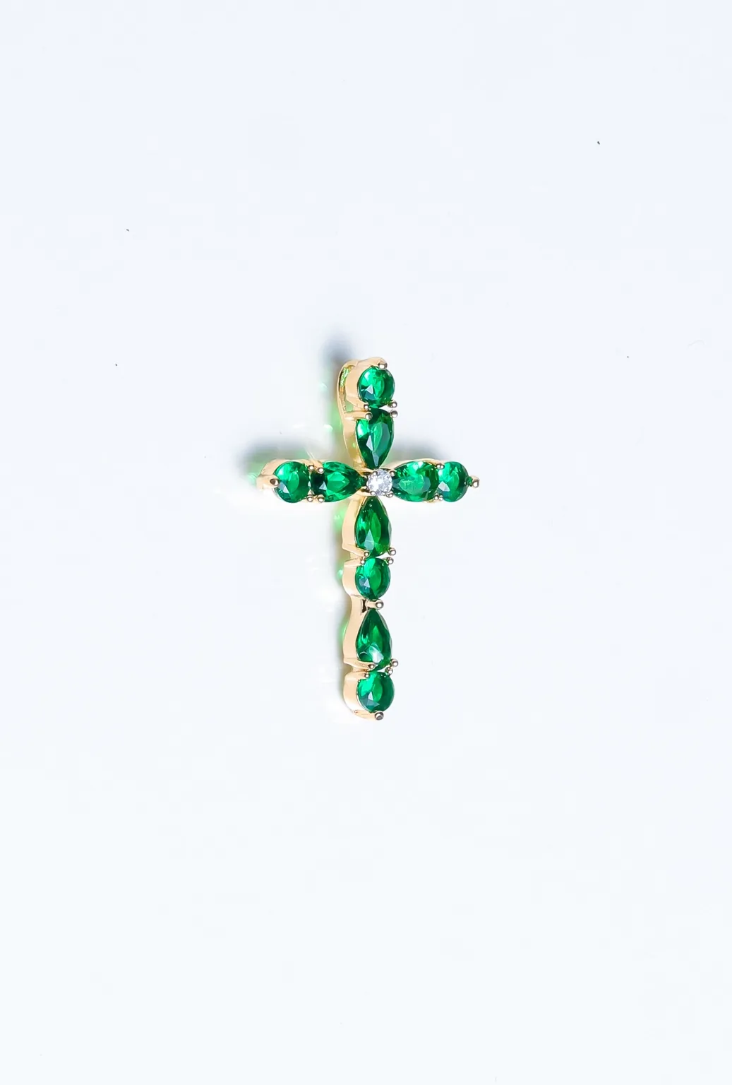 Emerald cross jewelry product photography by Rafael Torres